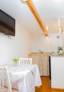 - une cuisine avec une table et une télévision dans la chambre dans l'établissement La serena, à San Carlos de Bariloche