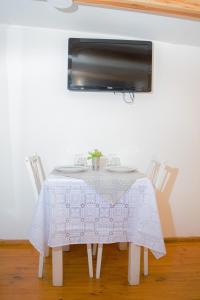 a white table with a white table cloth on it at La serena in San Carlos de Bariloche