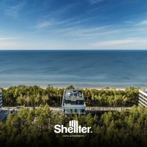 a view of a building with the ocean in the background at Seaside Shellter Rogowo in Rogowo
