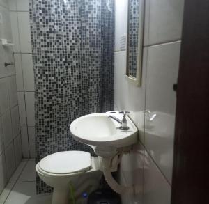 a bathroom with a sink and a toilet at Pousada Anhanguera in Ribeirão Preto +50 photos