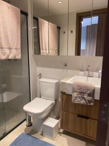 a bathroom with a toilet and a sink and a shower at Apartamento novo de alto padrão e aconchegante#224 in Brasilia