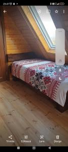 Bett in einem kleinen Zimmer mit Fenster in der Unterkunft Marian&Edy in Teceu Mic