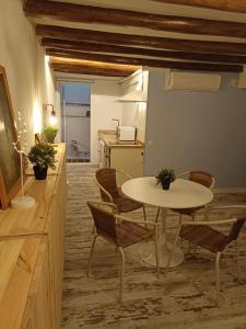 Habitación con mesa, sillas y cocina. en Petra apartments -Old City with terrace and barbecue-, en Tarragona