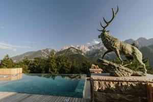a statue of a deer standing next to a pool at Chalet Sofija in Gozd Martuljek
