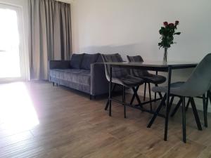 a living room with a table and a couch at Apartament Nowa letnica in Gdańsk