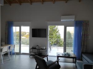 a living room with a couch and a table at GERAKOFOLIA-VILLA in Nikiana