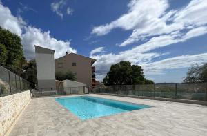 a swimming pool in a yard with a fence at Roses Marines A136 By Avecoeur in Grasse