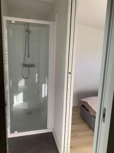 a glass door leading into a room with a bed at Robert's Family Petite Maison de Ville in Plancoët +57 photos