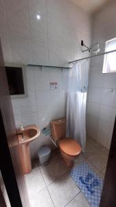 a bathroom with a toilet and a sink and a shower at POUSADA AMAZONAS in Rio das Ostras