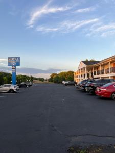 a parking lot with cars parked in front of a hotel at Royal Inn - Neptune in Neptune City