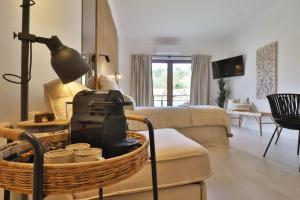 un soggiorno con un divano e una sedia con una valigia di Sun&Lounge Ericeira a Ericeira