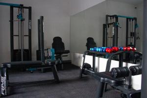 a gym with dumbbells and weights in a room at Cozy Home Salta in Salta