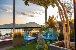 a table and chairs on a balcony with a view at Panorama Loft in Chalkida