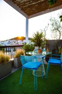 a patio with a table and chairs on a balcony at Panorama Loft in Chalkida