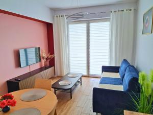 a living room with a blue couch and a table at Apartament Rubin in Zator