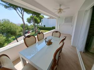 a dining room with a table and chairs and a large window at Rancho B 5 in Mijas Costa