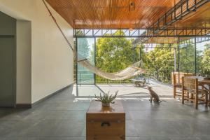 a hammock in the middle of a room with a cat at Rinconada Hotel Boutique in Iguala de la Independencia