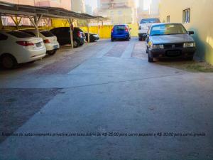 a group of cars parked in a parking lot at Estrela do Sul Hotel in Curitiba