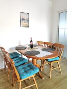 a dining room with a wooden table and chairs at Apartmani Gabi in Cesarica