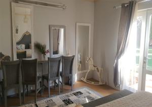a dining room with a table and chairs and a mirror at Perdehoek Venue in Lichtenburg