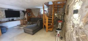 a living room with a couch and a television at Villa Thalia in Marinići