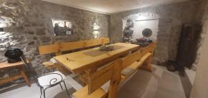 a wooden table in a room with a stone wall at Villa Thalia in Marinići