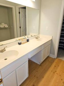 a bathroom with two sinks and a large mirror at Close to the beach and attractions! Perfect for families or traveling nurses! in Wilmington