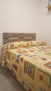 a bed with a comforter and pillows on it at Apartment in Salou. Beach Relax HUTT-033474-91 in Salou