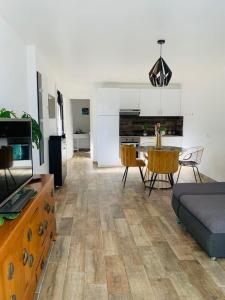 a living room with a couch and a table at Jolie Appartement Rez de jardin in Pégomas