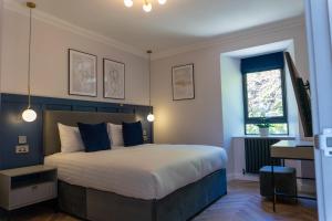 a bedroom with a large bed and a window at Oban Apartments in Oban