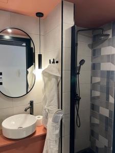 a bathroom with a sink and a shower at Eleven by Warren Collection in Sliema