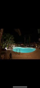a large blue swimming pool at night at B&B Villa Colomba in Agrigento