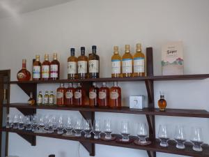 a bunch of wine bottles and glasses on shelves at Abashirikai no Taiyo - Vacation STAY 14415 in Abashiri