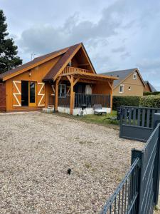 a home with a gambrel roof and a yard at Chalet rénové Cabourg in Cabourg