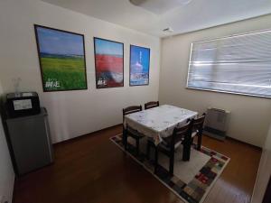 a dining room with a table and some pictures on the wall at Abashirikai no Taiyo - Vacation STAY 14415 in Abashiri