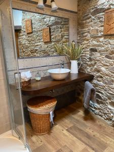 a bathroom with a sink and a stone wall at Casa da Costa de Sueiro in Sueiro +30 photos