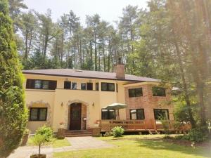 a large brick house with a porch at Gusthof Lumiere - Vacation STAY 41339v in Fujikawaguchiko