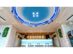 a large room with a blue ceiling and a table at La'gent Hotel Okinawa Chatan Hotel and Hostel - Vacation STAY 59141v in Fuenzan