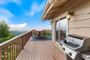 a balcony with a grill and a table and chairs at Golden Ridge Getaway in Blowing Rock