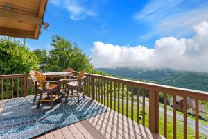 a table and chairs on a deck with a view at Golden Ridge Getaway in Blowing Rock +22 photos
