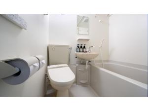 a bathroom with a toilet and a sink and a bath tub at La'gent Inn Kesennuma - Vacation STAY 85812v in Kesennuma