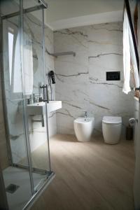 a bathroom with a shower and a sink and a toilet at B&B Villa Colomba in Agrigento