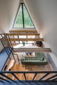 ein Loft mit einem Fenster und einem Sofa in einem Zimmer in der Unterkunft Namas MIŠKE 