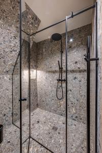 a shower with a glass door in a bathroom at Namas MIŠKE 