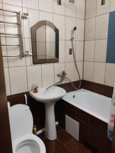 a bathroom with a sink and a toilet and a tub at Apartment on Victora Yarmoly in Kyiv