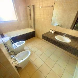 a bathroom with a toilet and a sink at Dubai Eye in Dubai