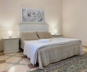 a bedroom with a bed with a painting on the wall at La Campanella in Manduria