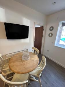 a dining room with a wooden table and chairs at A spacious flat in Cardiff