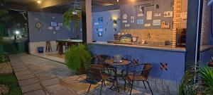 a patio with a table and chairs at a bar at Pousada Cheiro de Mato in Penedo