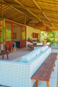a room with several couches and tables in a house at Pousada Rancho Luar in Pôrto de Pedras
